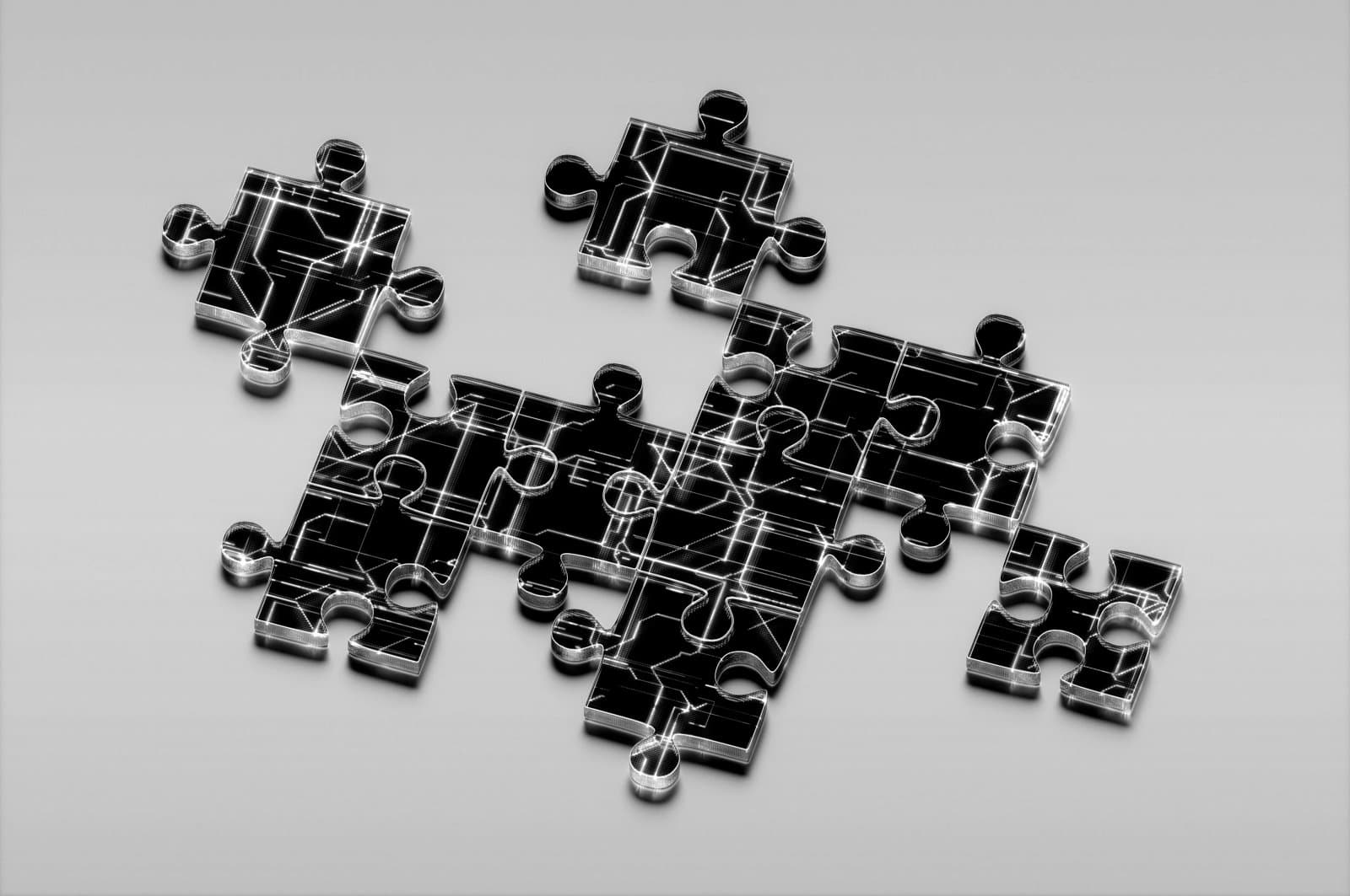 Interlocking jigsaw puzzle pieces with a circuit-board pattern
