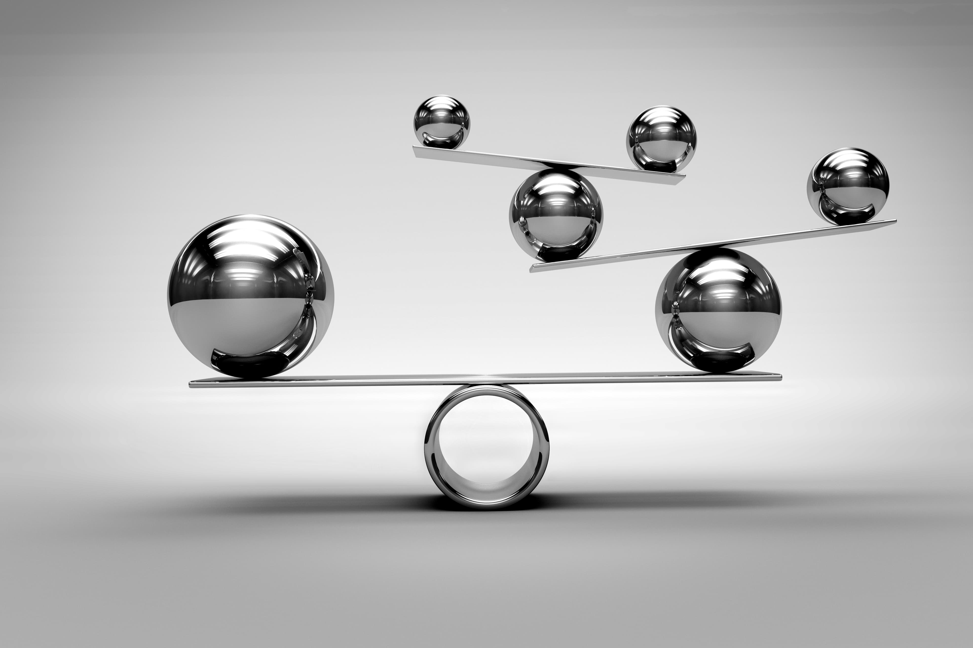 Close up of six balls balancing