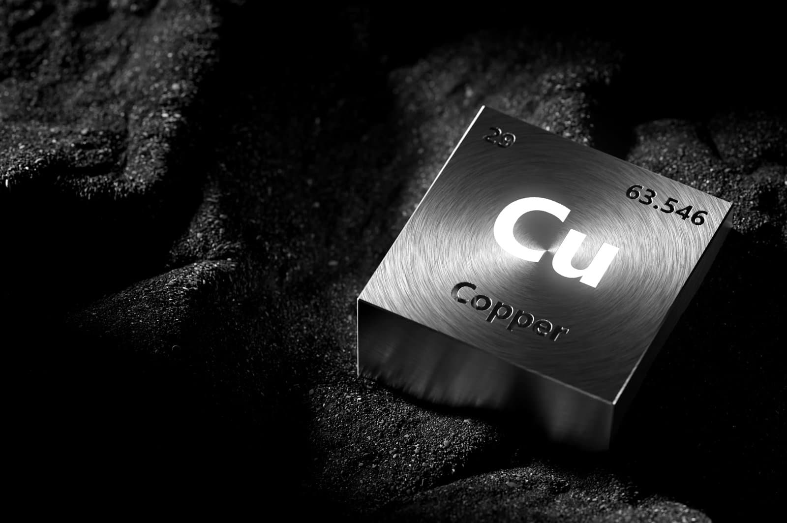 Metal block engraved with the chemical symbol for copper