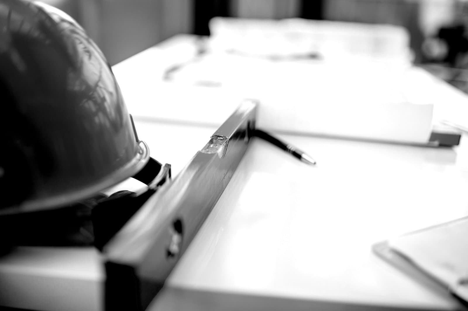 Table with hard-hat and blueprints