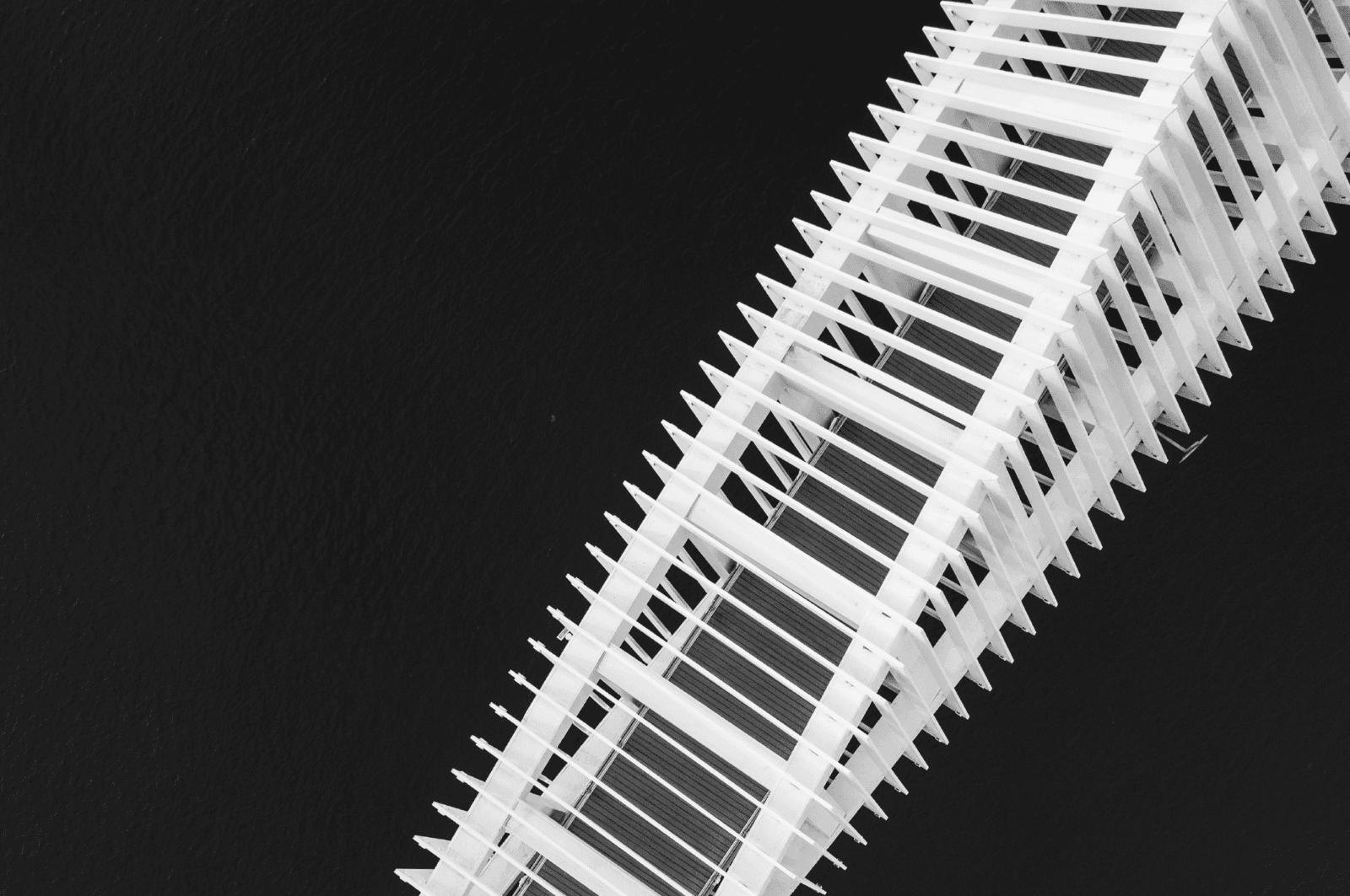 Aerial view of a metal foot bridge, above water