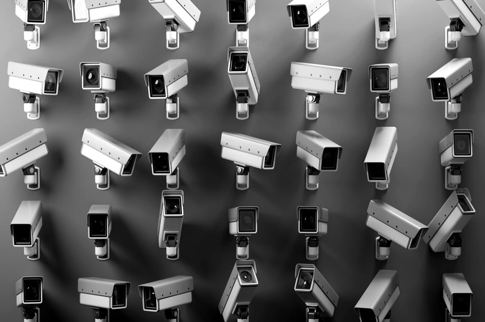 An array of multiple security cameras mounted on a wall